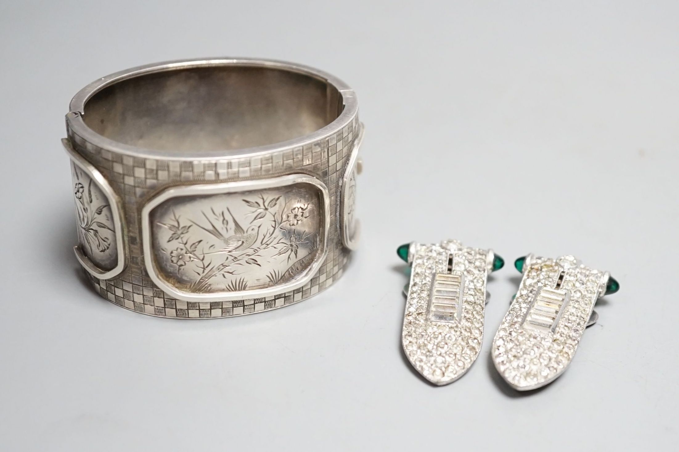 A pair of art deco paste clip earrings and a sterling bangle.